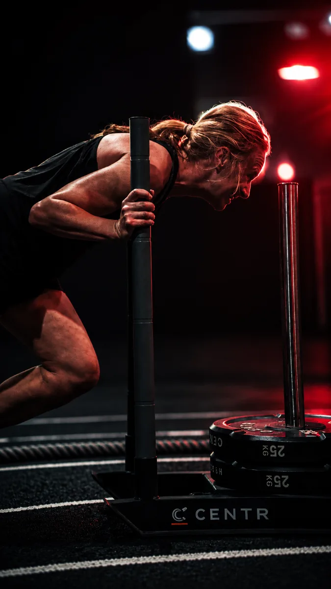 Member pushing a weighted sled on the District A functional track